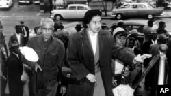 FILE -Rosa Parks arrives at circuit court to be arraigned in the racial bus boycott in Montgomery, Alabama, Feb. 24, 1956.