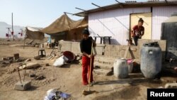 A woman cleans her home in Villa Maria del Triunfo, a shanty town on the outskirts of Lima, Peru, May 9, 2017.