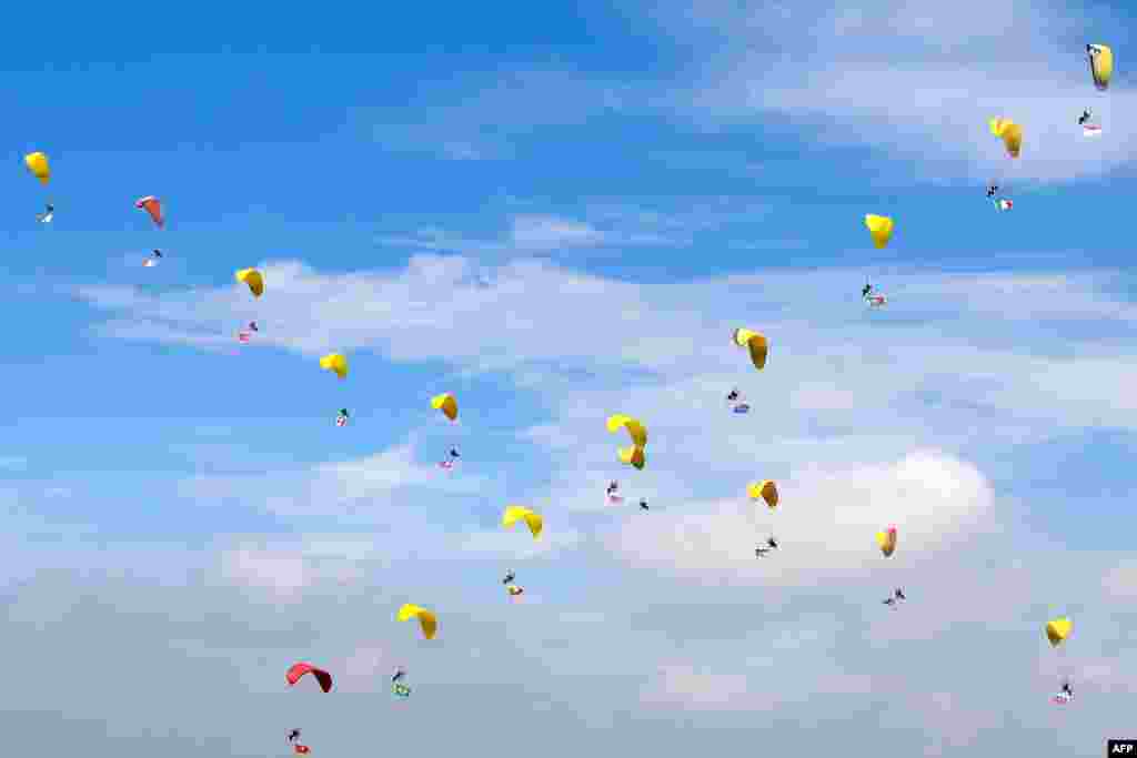 Parachutists perform during the opening ceremony of the 6th Shenyang Faku International Flight Convention in the capital of Liaoning province, China.