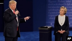 Republican presidential nominee Donald Trump speaks to Democratic presidential nominee Hillary Clinton during the second presidential debate at Washington University in St. Louis, Sunday, Oct. 9, 2016.