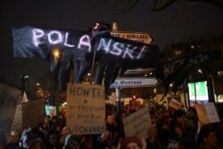 Women's rights activists protest against multiple nominations for Roman Polanski at the Cesar Awards ceremony, in Paris, France, Feb. 28, 2020.