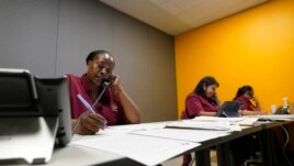 Tnisha Nation, left, Sandrea Guerrero, center, and Elena Mojica reach out to families in the San Antonio Independent School District, Tuesday, June 8, 2021, in San Antonio. (AP Photo/Eric Gay)