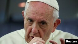 FILE: Pope Francis gestures during a news conference on board of the plane during his flight back from a trip to Chile and Peru, January 22, 2018.