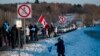 People gather along the trans-Canadian highway to show support for the "Freedom Convoy", protesting against Covid-19 related mandates in Rigaud, Quebec on Jan. 28, 2022. 