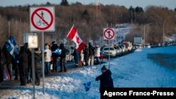 People gather along the trans-Canadian highway to show support for the "Freedom Convoy", protesting against Covid-19 related mandates in Rigaud, Quebec on Jan. 28, 2022. 