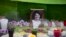 FILE - A framed image of environmentalist Berta Caceres on a makeshift altar made in her honor during a demonstration outside Honduras' embassy, in Mexico City, June 15, 2016. 