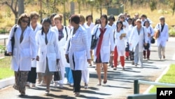 Foreign physicians — mainly Cuban — arrive at the University of Brasilia for a meeting with the Brazilian Health Minister, in Brasilia on Aug. 26, 2013. The Brazilian government hired thousands of foreign doctors due to the lack of medical professionals.
