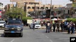 Iraqi security forces close the scene of a suicide bomb attack at a gathering of construction workers in the eastern New Baghdad neighborhood, Iraq, Sept. 27, 2016.