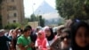 In the shadow of the Giza Pyramids, voters wait to cast their ballots in the presidential election in Giza, May 26, 2014. 