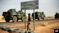 FILE - French armored vehicles head toward the Niger border before making a left turn north in Gao, northern Mali.