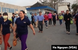 Factory hands leave work at the end of the day in Dong Nai Province, Vietnam, one of the places drawing investors beyond the biggest cities.