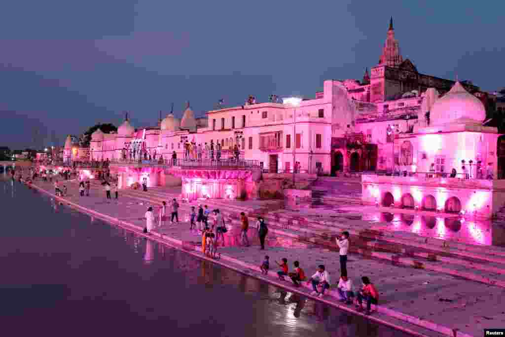 Temples and other buildings on the bank of Sarayu river are seen illuminated ahead of the foundation-laying ceremony for a Hindu temple in Ayodhya, India, Aug. 4, 2020.