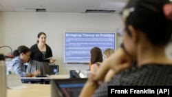 Dr. Lindsay Portnoy leads a class in early childhood development at Hunter College in New York, during which her students use devices to take notes.