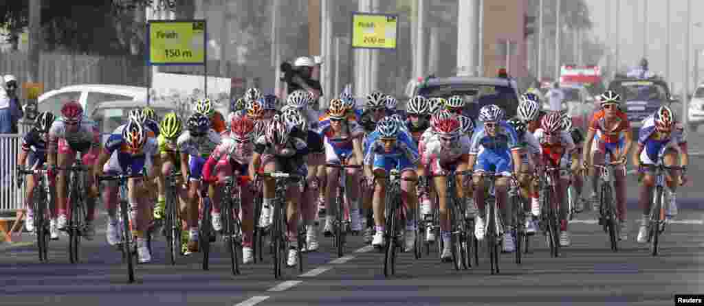 Cyclists compete in the 97-km first stage of the Tour of Qatar women&#39;s cycling race from Doha to Mesaieed, Qatar.