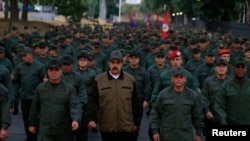 Venezuela's President Nicolas Maduro walks next to Venezuela's Defense Minister Vladimir Padrino Lopez and Remigio Ceballos, Strategic Operational Commander of the Bolivarian National Armed Forces, during a ceremony at a military base in Caracas, Venezuela, May 2, 2019.