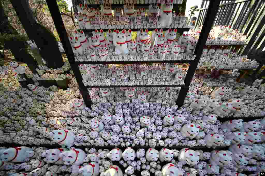 Thousands of &quot;Maneki-neko,&quot; or beckoning cat, figurines are placed at the Goutokuji Temple in Tokyo, Japan.
