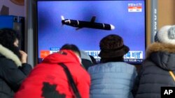 FILE - People watch a TV showing a file image of North Korea's missile launch during a news program at the Seoul Railway Station in Seoul, South Korea, Jan. 25, 2022.