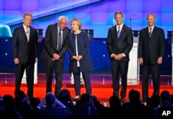 Democratic presidential candidates, from left, former Virginia Sen. Jim Webb, Sen. Bernie Sanders of Vermont, former Secretary of State Hillary Clinton, former Maryland Gov. Martin O'Malley and former Rhode Island Gov. Lincoln Chafee, take the stage befor