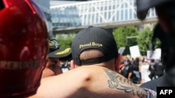 FILE - A person wears a hat of U.S. far-right men's organization Proud Boys during a campaign rally for Patriot Prayer founder and Republican Senate candidate Joey Gibson in Portland, Ore., Aug. 4, 2018.
