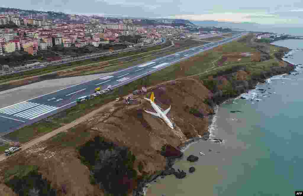 A Pegasus Airlines Boeing 737 passenger plane is seen struck in mud on an embankment, a day after skidding off the airstrip, after landing at Trabzon's airport on the Black Sea coast, Turkey.
