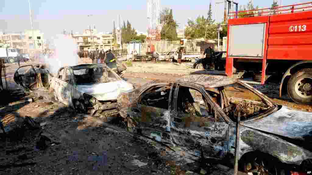 In this photo released by the Syrian official news agency SANA, damages cars are seen after an explosion hit a university in Aleppo, Syria, January 15, 2013.