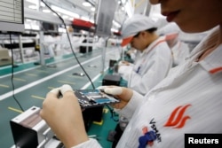 A manufacturer works at an assembly line of Vingroup's Vsmart phone in Hai Phong, Vietnam, Dec. 4, 2018.