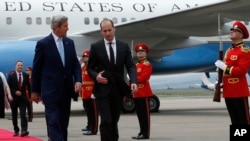 U.S. Secretary of State John Kerry, left, and Georgia's Foreign Minister Mikheil Janelidze walk upon arrival at Tbilisi International Airport, Georgia, July 6, 2016.