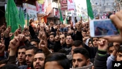 Hamas supporters chant slogans while raising their hands up during protest against President Donald Trump's decision to recognize Jerusalem as Israel's capital, in Jebaliya Refugee Camp, Gaza Strip, Dec. 8, 2017. 