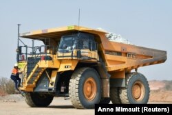 Tene Konate, 42, a truck driver, climbs on her dumper truck at the gold mine site in Hounde, Burkina Faso February 12, 2020