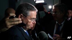 Sen. Bob Menendez, D-N.J., pauses while speaking to the media after attending a closed-door meeting of the Congressional Hispanic Caucus and Homeland Security Secretary Kirstjen Nielsen, July 25, 2018, on Capitol Hill in Washington.