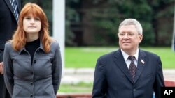 FILE - Maria Butina walks with Alexander Torshin then a member of the Russian upper house of parliament in Moscow, Russia, Sept. 7, 2012.
