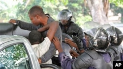 Young men suspected of being militant supporters of opposition candidate Etienne Tshisekedi are forced into a police truck as they are arrested near opposition party headquarters in the Limete district of Kinshasa, Congo, December 12, 2011.