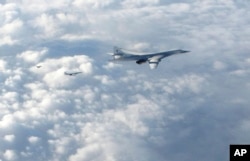In this image made available by the Royal Air Force, Jan. 15, 2018, two Russian Blackjack Tupolev Tu-160 long-range bombers are followed by an RAF Typhoon aircraft, left, scrambled from RAF Lossiemouth, Scotland.