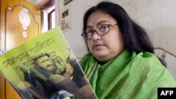 In this file photo taken on March 6, 2003, Indian author Sushmita Banerjee holds one of her novels.