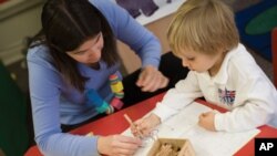 A teacher works with a student at the British School of Chicago, where lessons are individualized based upon how the student learns.