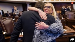 Florida Sen. Lauren Book, right, embraces Sen. Bill Galvano after Galvano's bill, the Marjory Stoneman Douglas High School Student Safety Act, passed 20-18 at the Florida Capitol in Tallahassee, Florida, March 5, 2018.