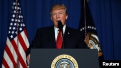 FILE - U.S. President Donald Trump delivers a statement about missile strikes on a Syrian airbase, at his Mar-a-Lago estate in West Palm Beach, Florida.