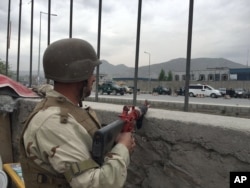 An Afghan soldier responds to a Taliban-claimed suicide attack in Kabul, Afghanistan, Tuesday, April 19, 2016.