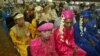 FILE - Indonesian couples wait for their turn to wed during a 47-couple mass wedding ceremony in Jakarta, Indonesia, in 2005.