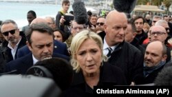 Far right leader and presidential candidate Marine Le Pen arrives to pay homage to the 86 victims of an attack last year, Monday Feb. 13, 2017 in Nice, southern France. (AP Photo/Christian Alminana)
