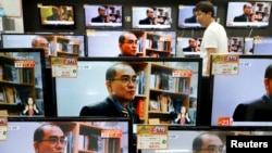FILE - A customer watches TV sets broadcasting a news report on Thae Yong Ho, North Korea's former deputy ambassador in London, who defected with his family to South Korea, in Seoul, South Korea, Aug. 18, 2016.