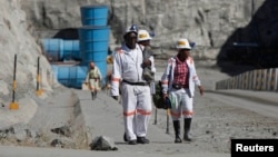 FILE - Workers return from a shift at Zimplats' Ngwarati Mine in Mhondoro-Ngezi, May 30, 2014. A recent leak of documents alleges Zimplats used an offshore company to pay management salaries.