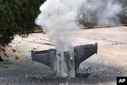 Smoke rises from a missile, which according to the Lebanon national news agency appears to be part of a Syrian air defense missile targeting an Israeli jet which landed in a lemon grove, Feb. 10, 2018.