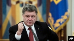 FILE - Ukrainian President Petro Poroshenko, shown speaking to his national security council in mid-February, discussed EU-mediated peace agreements Saturday with U.S. Vice President Joe Biden.