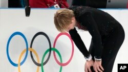 Yevgeny Plushenko of Russia skates on the ice prior to pulling out of the men's short program figure skating competition due to illness at the Iceberg Skating Palace during the 2014 Winter Olympics, Feb. 13, 2014, in Sochi, Russia.