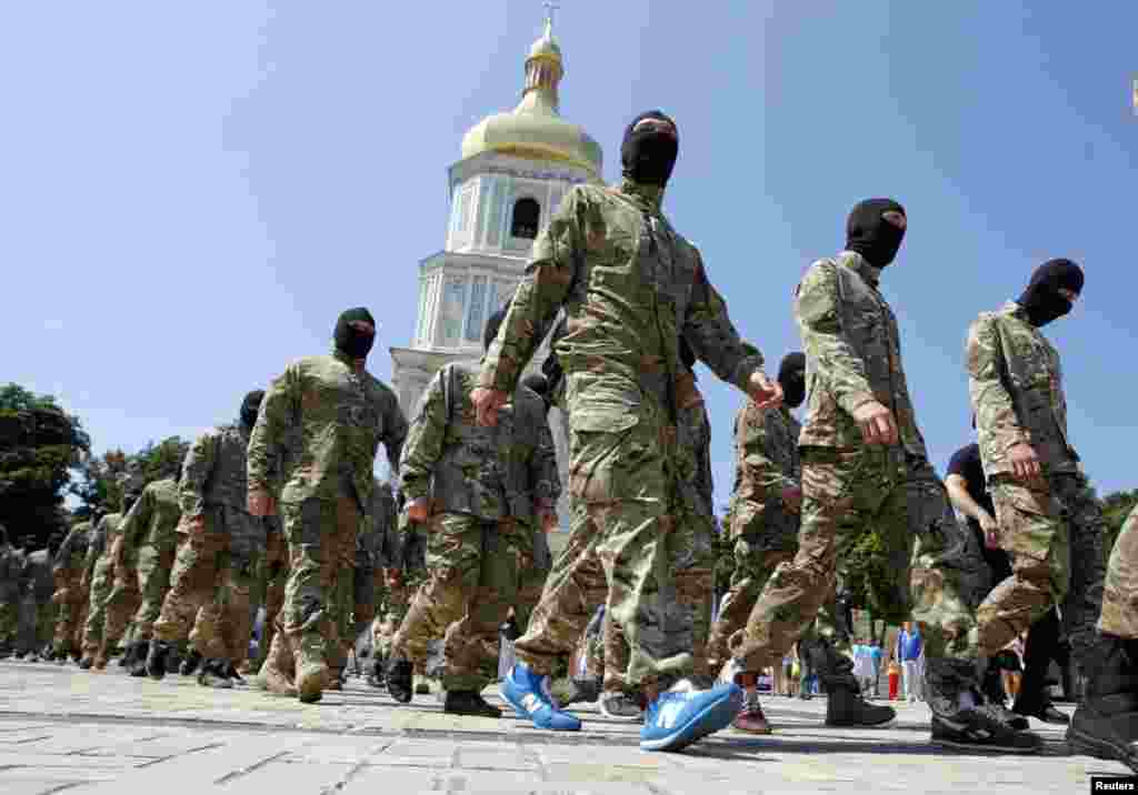New volunteers of the Ukrainian self-defence battalion &quot;Azov&quot; walk in front of Saint Sophia Cathedral before taking their oath of allegiance to their country, in Kyiv, July 16, 2014.