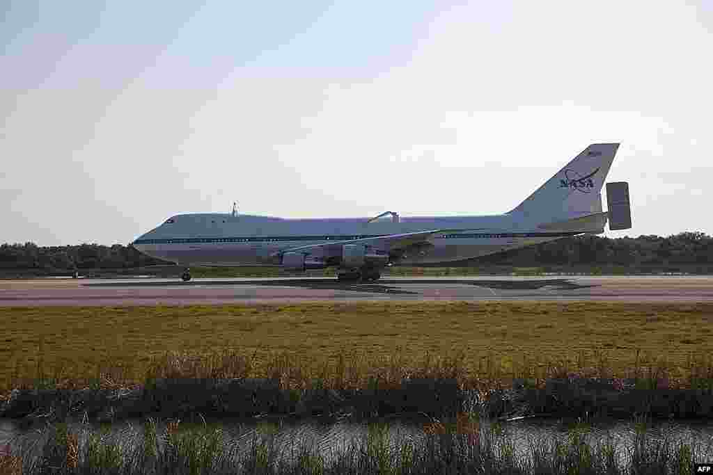 The Shuttle Carrier Aircraft arrives at the Shuttle Landing Facility at NASA's Kennedy Space Center in Florida to prepare for space shuttle Discovery's ferry flight to Virginia, April 10, 2012 . (NASA) 