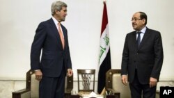 U.S. Secretary of State John Kerry, left, meets with Iraqi Prime Minister Nouri al-Maliki, right, at the Prime Minister's office in Baghdad on Monday, June 23, 2014