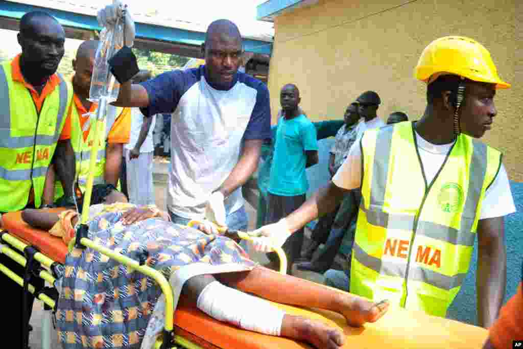 Medical officials treat a victim of a bomb blast at a Catholic church outside Abuja. (AP).
