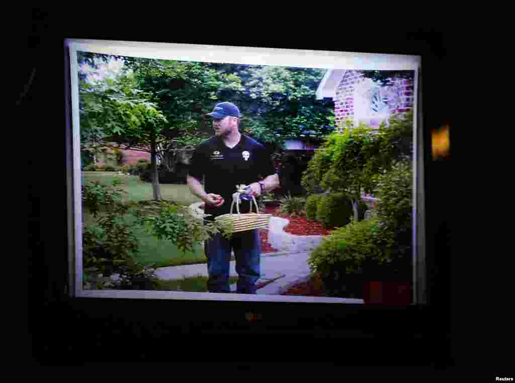 An image of slain Navy SEAL Chris Kyle hiding Easter eggs on Easter day is shown on a monitor in the courtroom during the murder trial of former Marine Cpl. Eddie Ray Routh in Stephenville, Texas, Feb. 11, 2015.